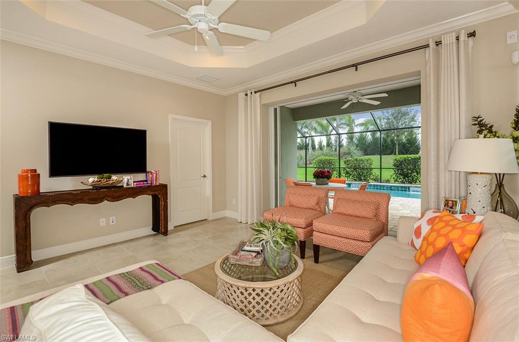4665 Centaurus Circle Naples, FL 34120 - Photo 3 of 16 a living room with furniture a flat screen tv and a large window