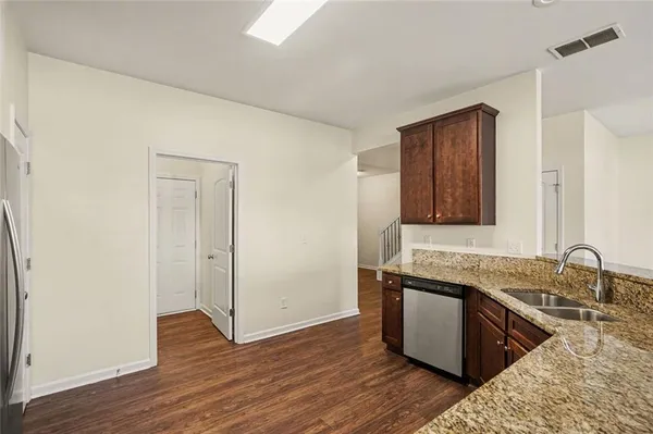 a view of a kitchen counter space and wooden floor
