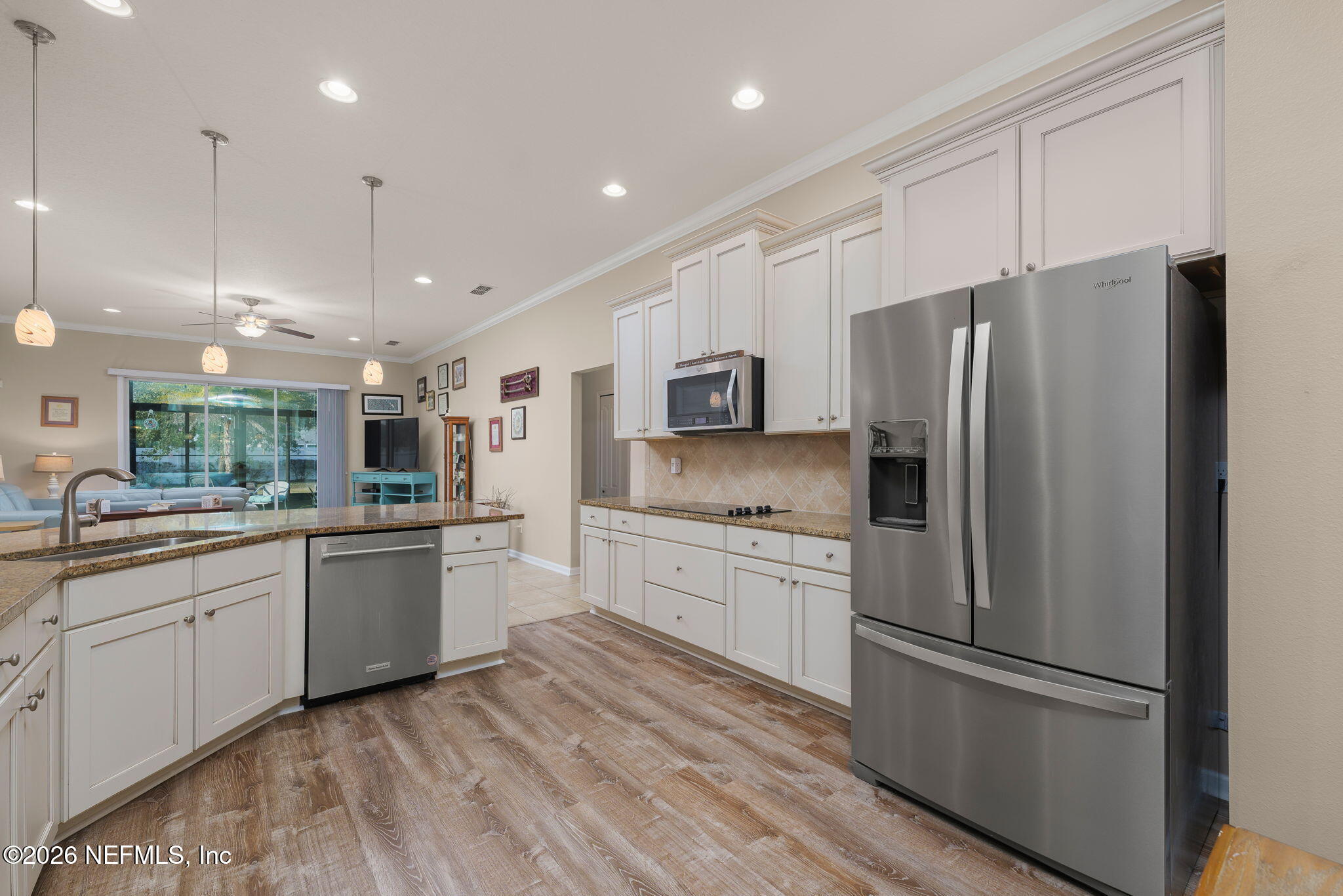 405 Porta Rosa Circle St. Augustine, FL 32092 - Photo 12 of 55 a large kitchen with a refrigerator a sink dishwasher a oven with white cabinets and wooden floor