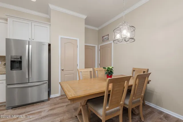 a large kitchen with kitchen island a dining table and chairs