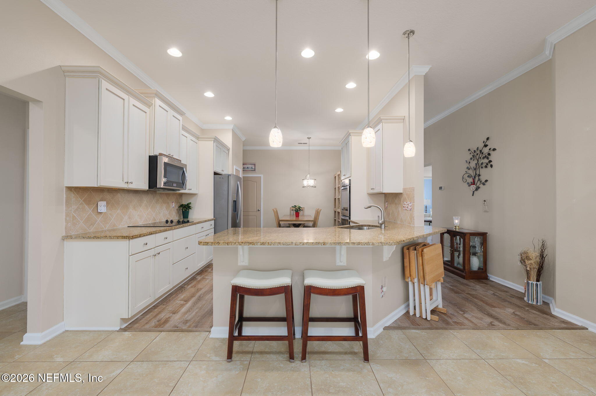 405 Porta Rosa Circle St. Augustine, FL 32092 - Photo 16 of 55 a large kitchen with kitchen island a dining table and chairs