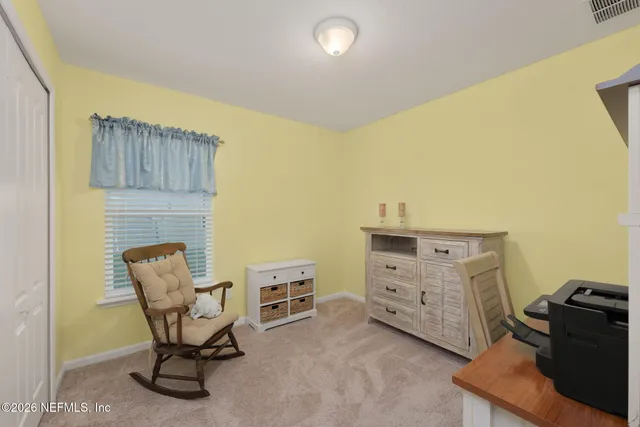 a bedroom with a bed and a ceiling fan