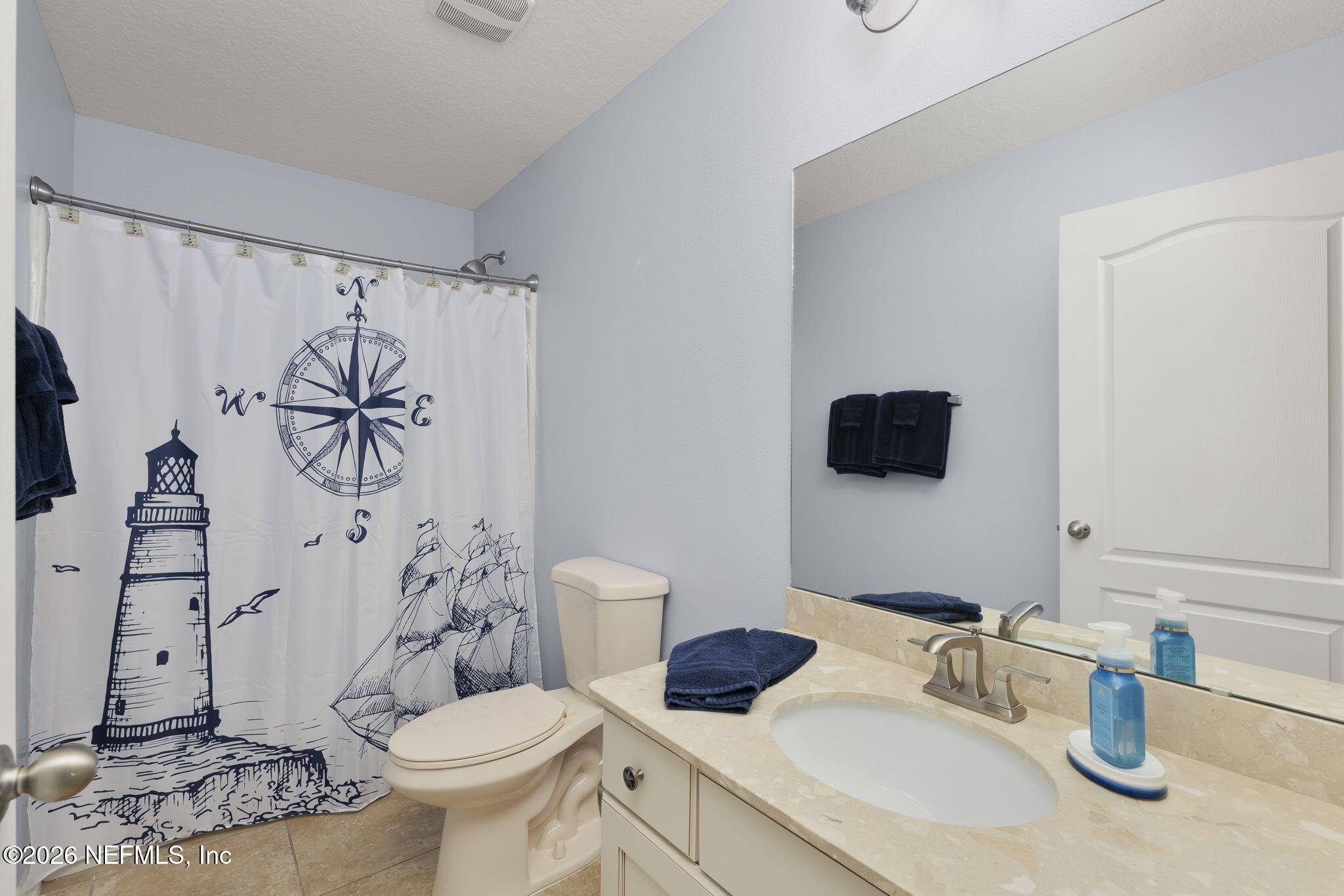 405 Porta Rosa Circle St. Augustine, FL 32092 - Photo 29 of 55 a bathroom with a toilet sink and shower curtain