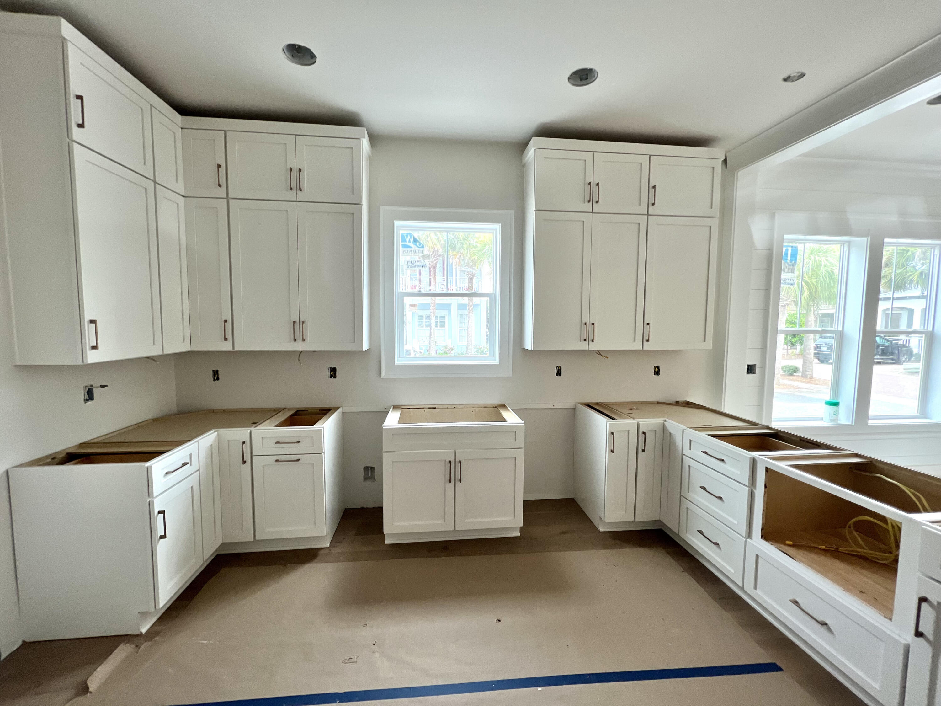 40 Sand Flea Dr Inlet Beach Inlet Beach, FL 32461 - Photo 6 of 37 a kitchen that has a lot of white cabinets and stainless steel appliances
