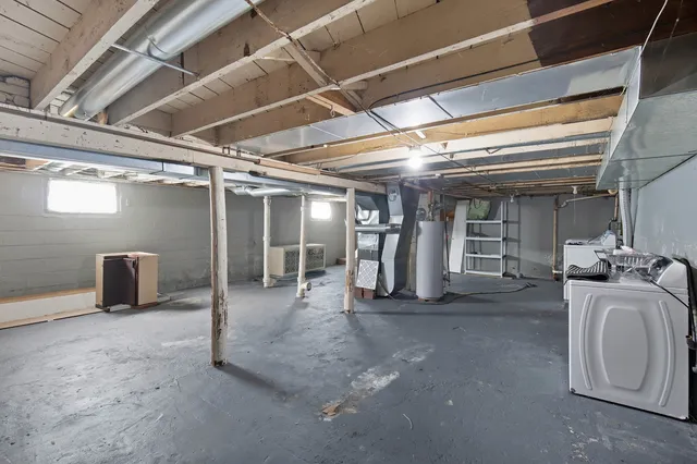 a view of house with backyard and trees in the background