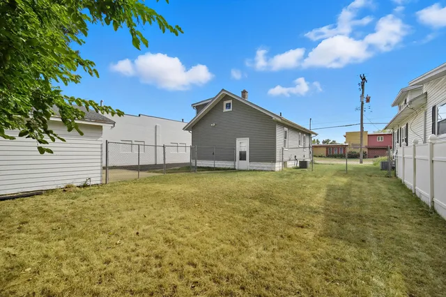 a white house that has a tree in front of it