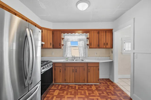 a kitchen with stainless steel appliances granite countertop a refrigerator and a sink