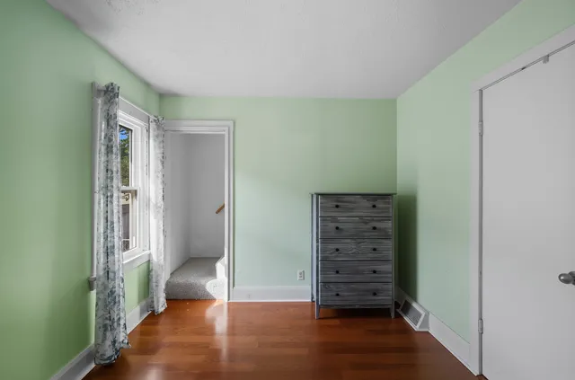 a view of walk in closet with wooden floor