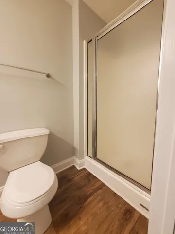 a bathroom with a toilet and a shower
