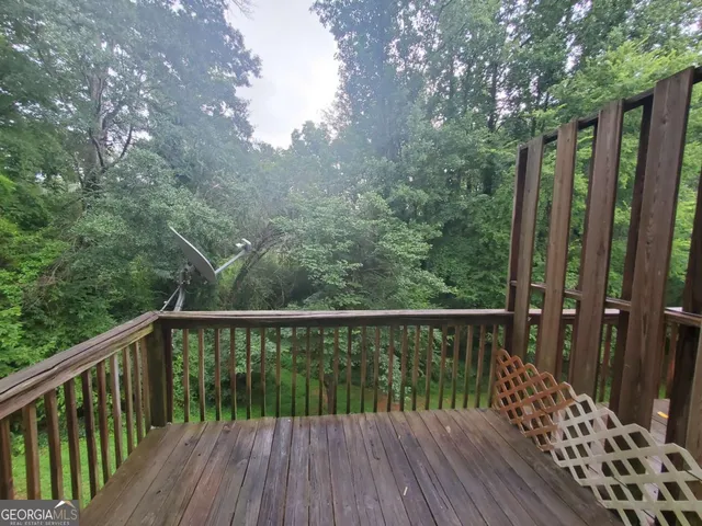 a balcony with wooden floor and outdoor space