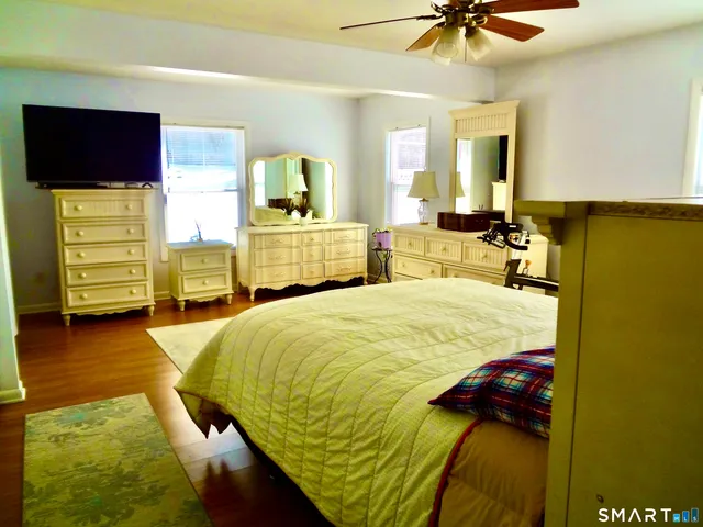 a bed room with a bed and a television