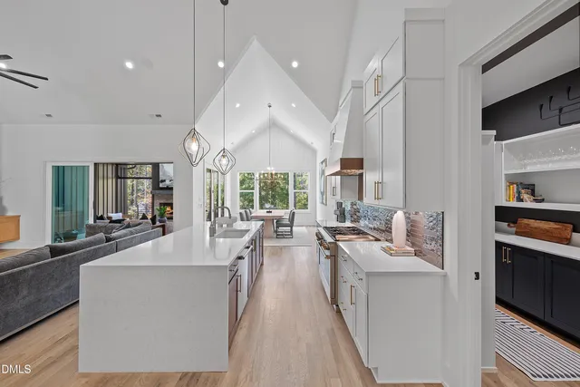a living room with furniture and a chandelier