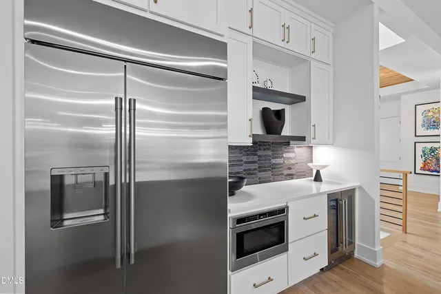 a bathroom with a sink a toilet a mirror and shower