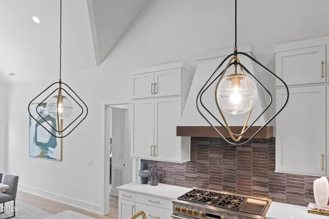 a living room with furniture a large window wooden floor and a rug