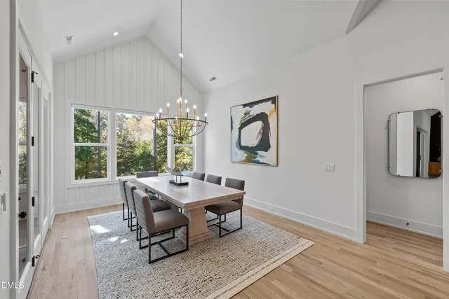 a living room with furniture a flat screen tv and a large window