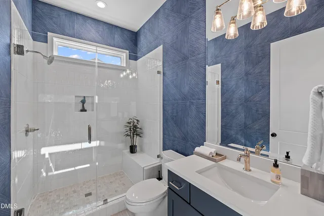 a bathroom with double vanity sinks and a mirror