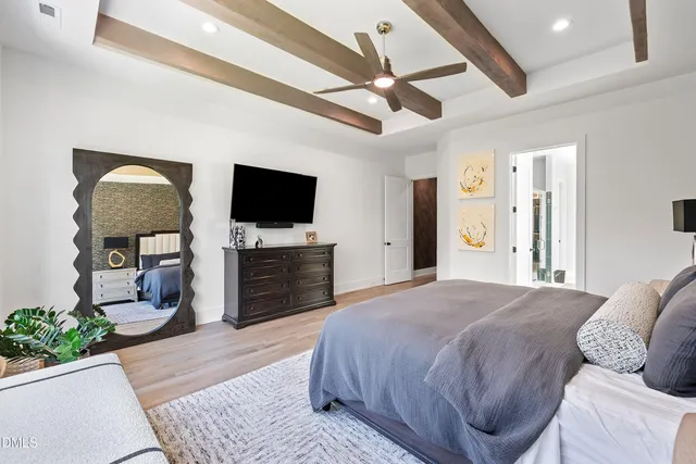 a view of a white house with a big yard and large trees