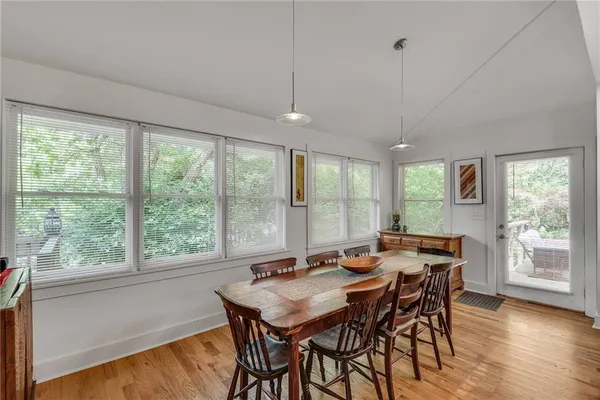 a view of a dining room with furniture window and wooden floor