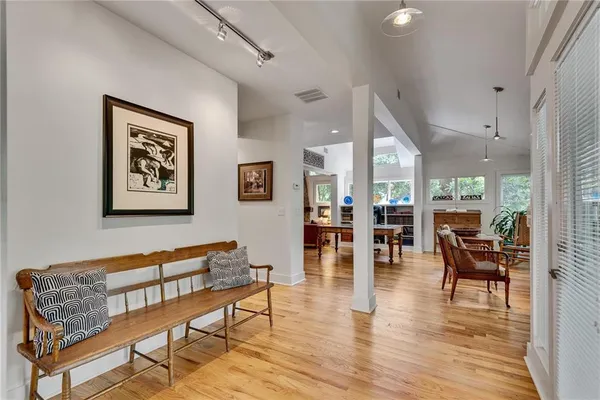a living room with furniture and wooden floor