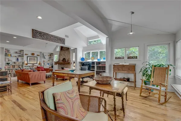 a living room with lots of furniture and a large window