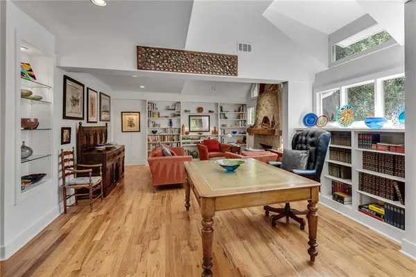 a view of a workspace with furniture window and wooden floor