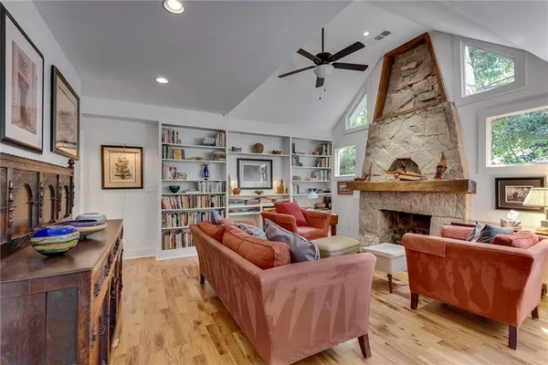 a living room with furniture a fireplace and a flat screen tv