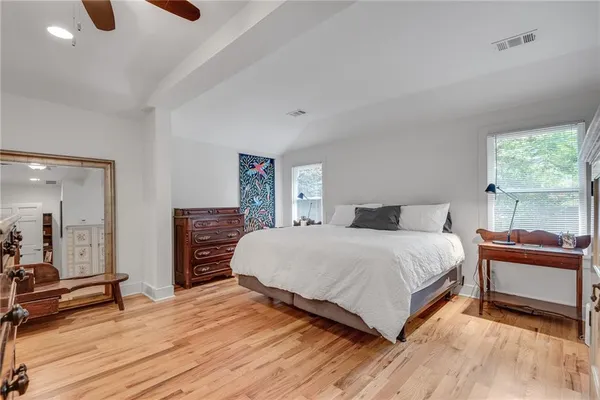 a bedroom with a bed and a large mirror