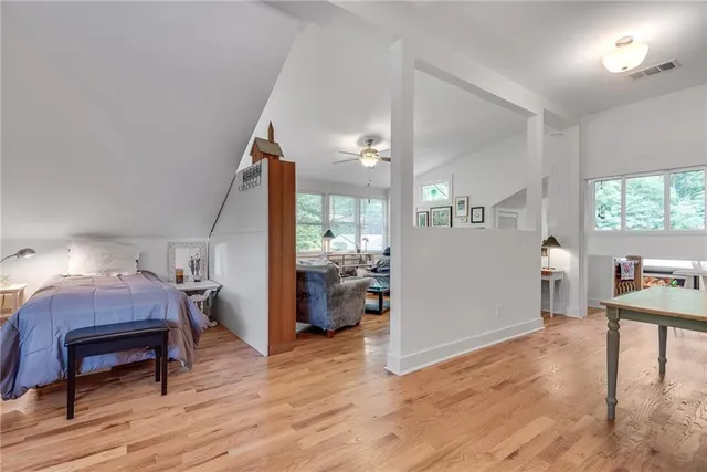 a bedroom with furniture and a wooden floor