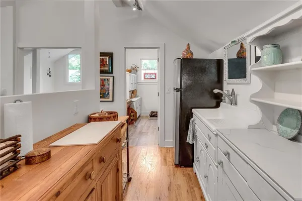a kitchen with a sink stove and refrigerator