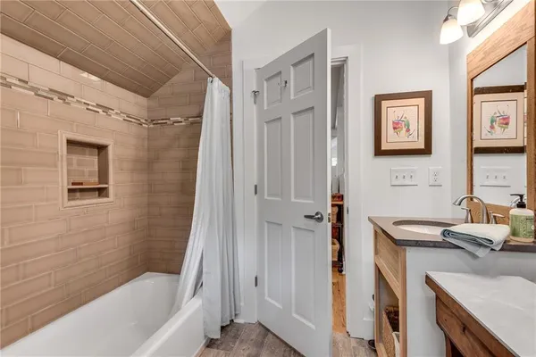 a bathroom with a tub sink and a shower