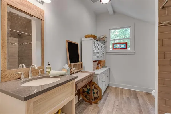 a bathroom with a sink vanity granite and a mirror