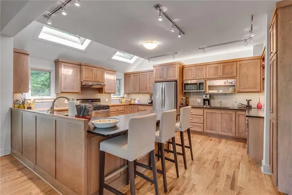 a kitchen with counter top space a sink appliances and cabinets