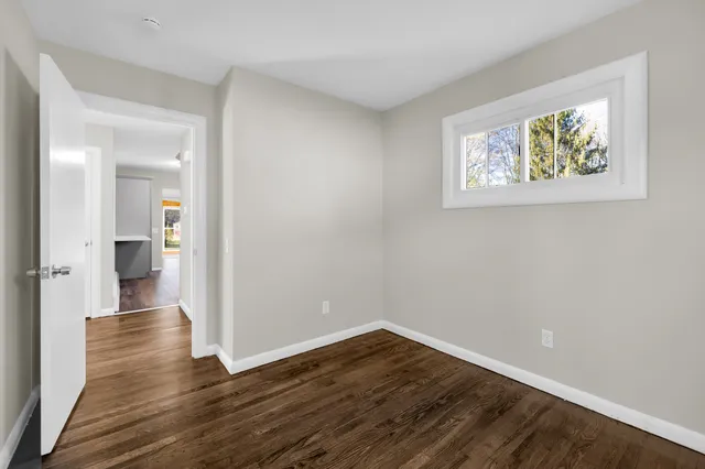 wooden floor in a hall with an empty room