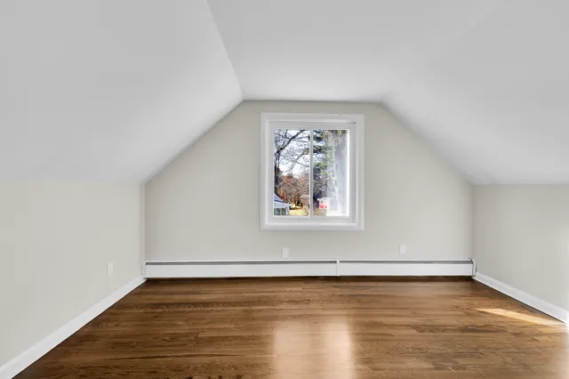 a view of a room with wooden floor and window