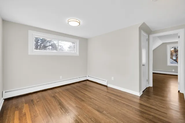 wooden floor in a hall with an empty room