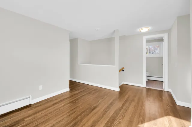 a view of a room with wooden floor