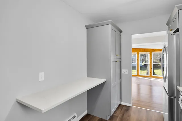 a view of an entryway with wooden floor