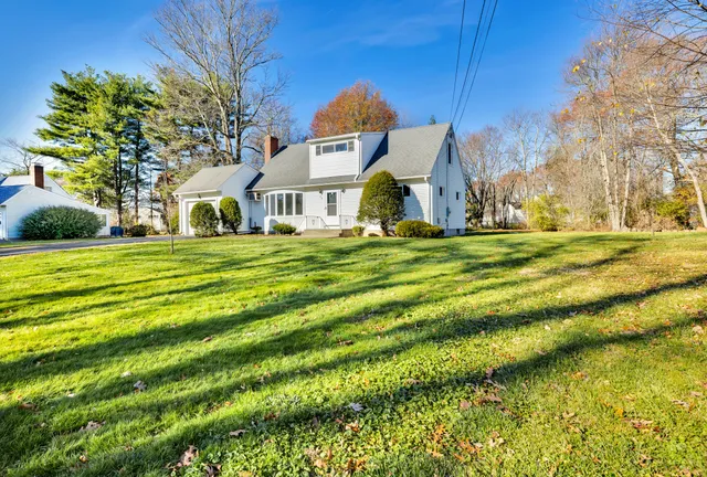 a front view of house with yard and green space