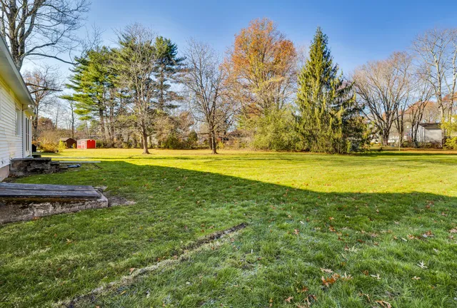 a view of a swimming pool and a yard