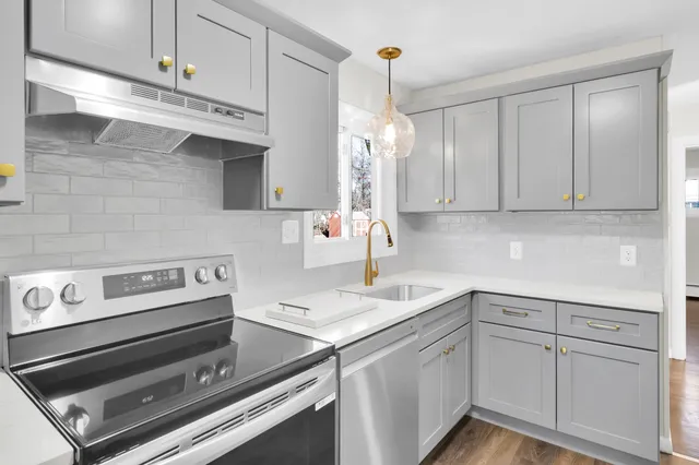 a kitchen with a sink cabinets and appliances