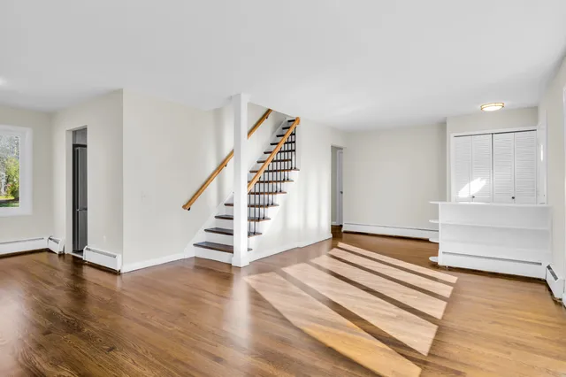 a view of entryway and hall with wooden floor