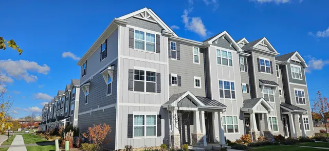 a front view of a building with a yard