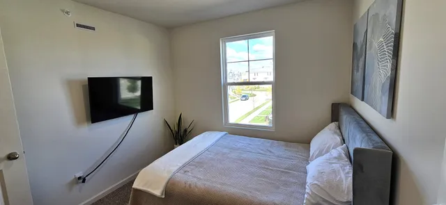 a bedroom with a bed and a window