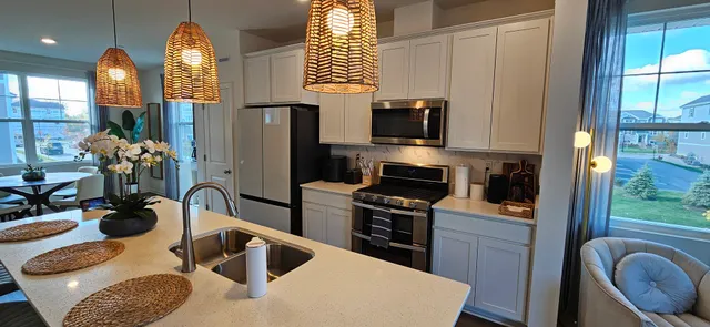 a kitchen with a refrigerator sink and stove