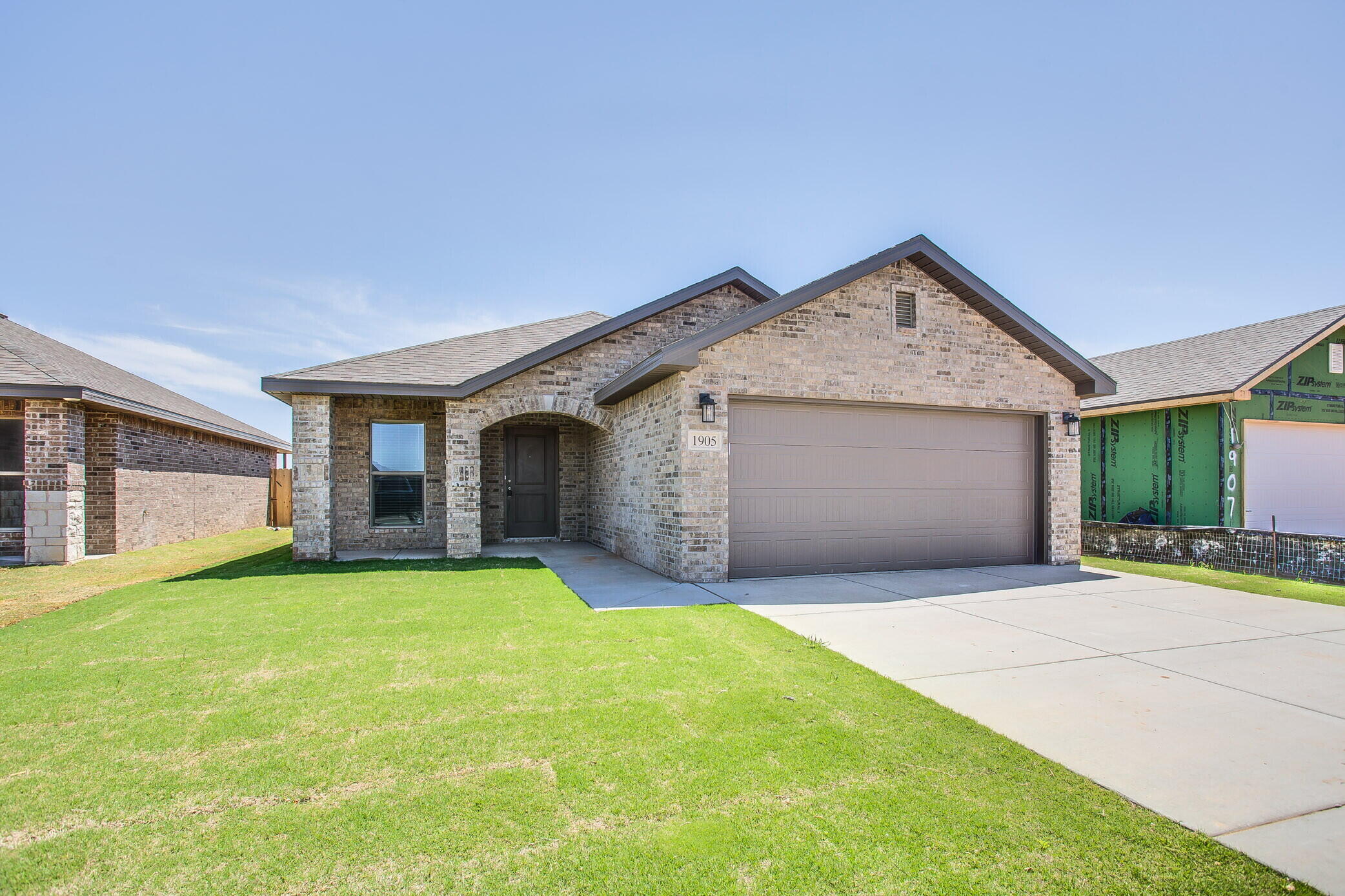 a view of a house with a yard and garage