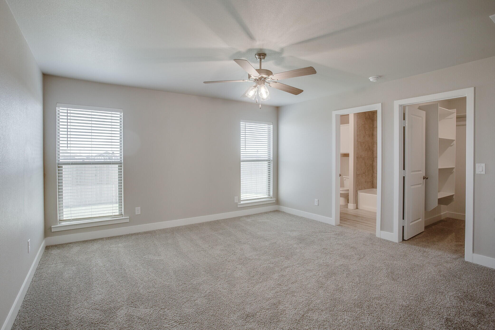 1905 140th Street Lubbock, TX 79423 - Photo 11 of 19 an empty room with chandelier fan and windows