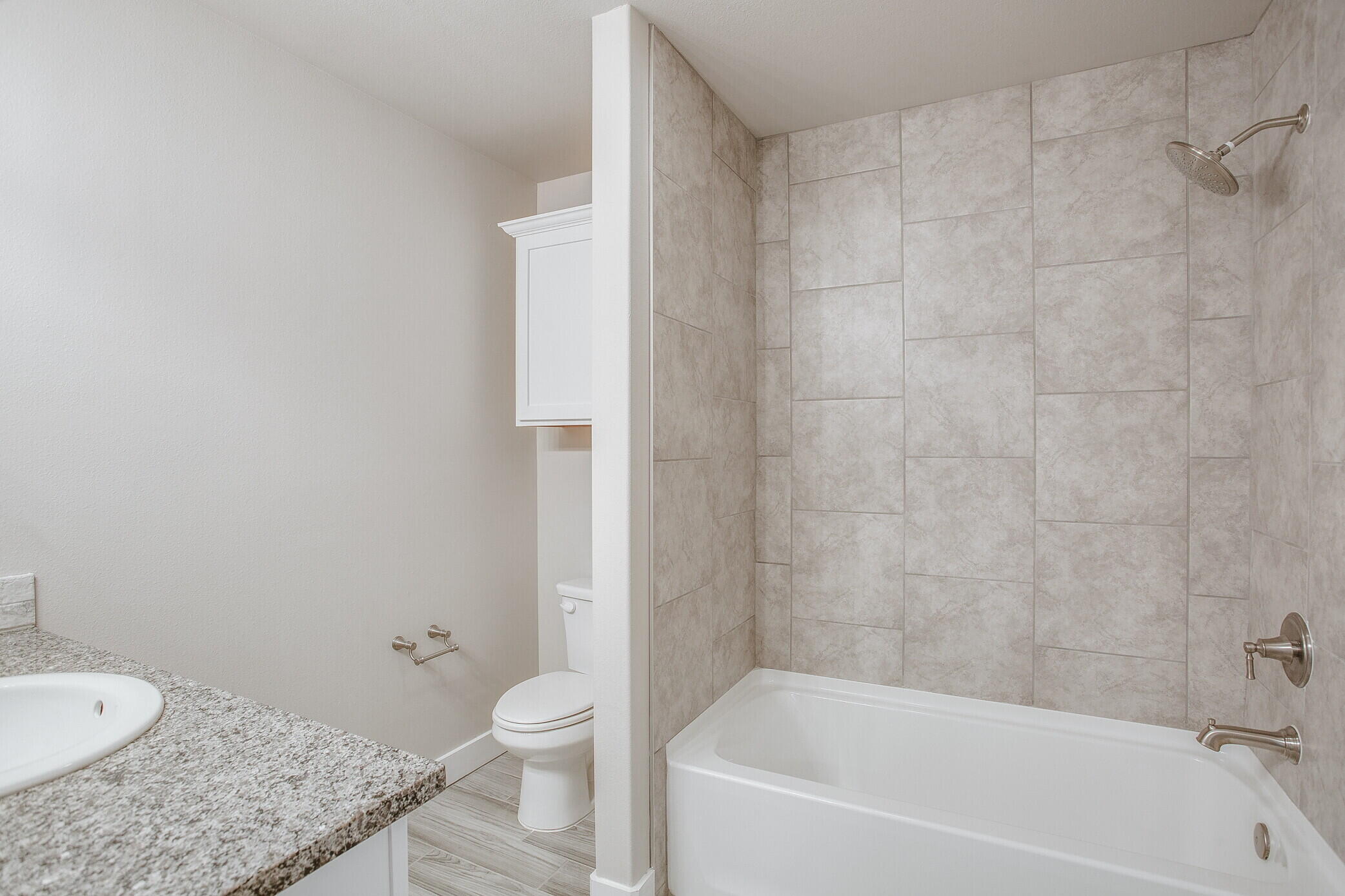 1905 140th Street Lubbock, TX 79423 - Photo 12 of 19 a bathroom with a granite countertop sink toilet and bathtub