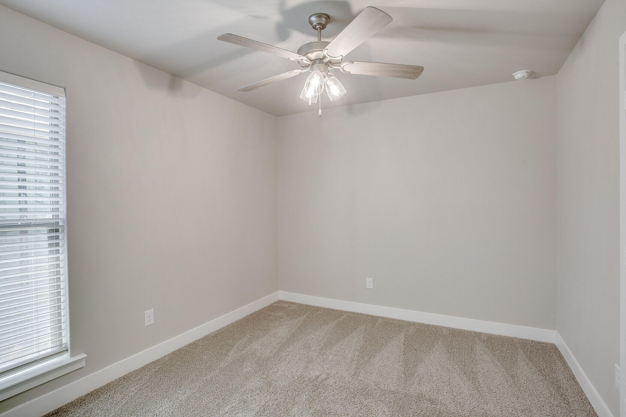 1905 140th Street Lubbock, TX 79423 - Photo 15 of 19 an empty room with a window and a fan