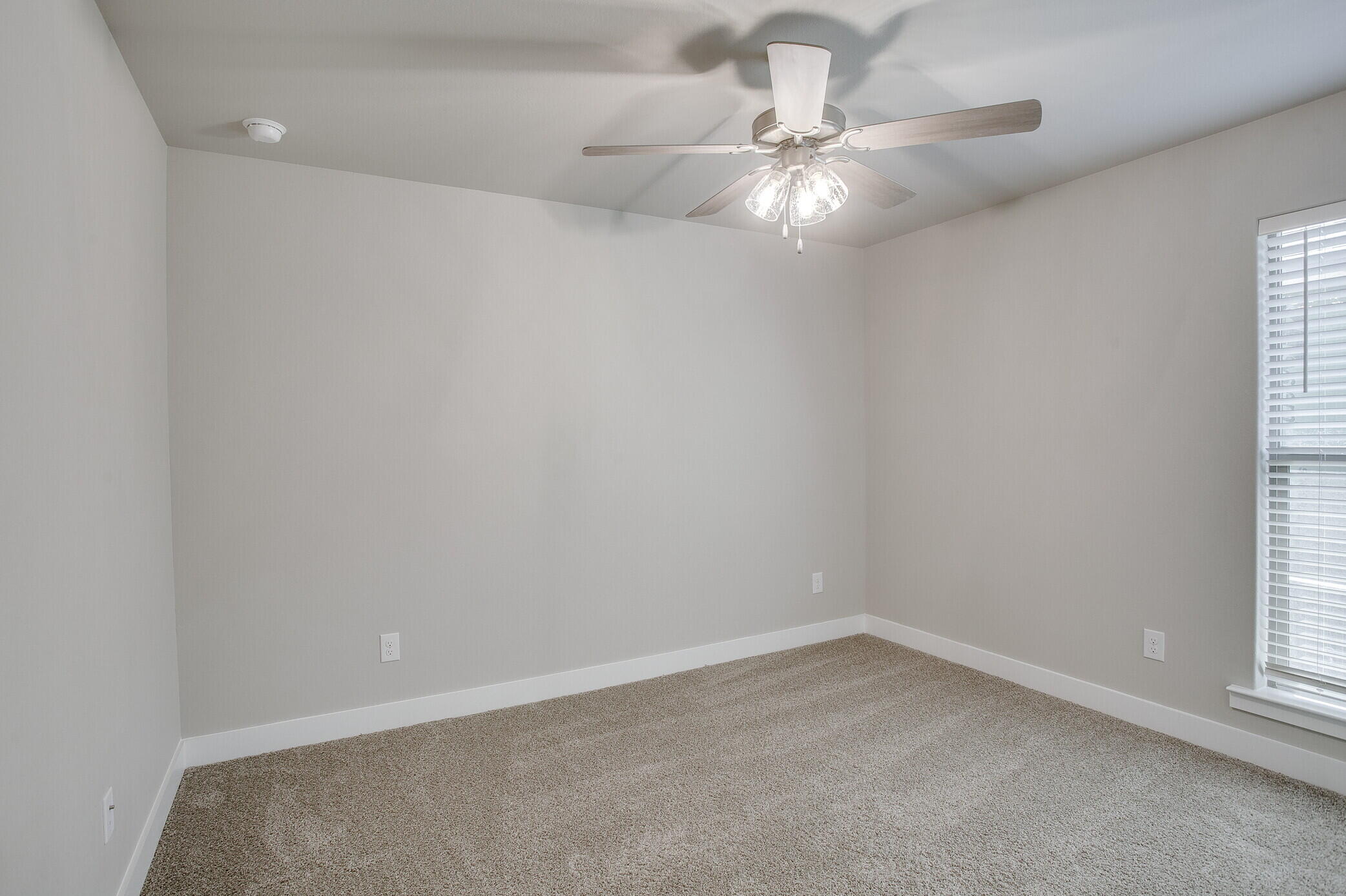 1905 140th Street Lubbock, TX 79423 - Photo 16 of 19 an empty room with a window and a fan