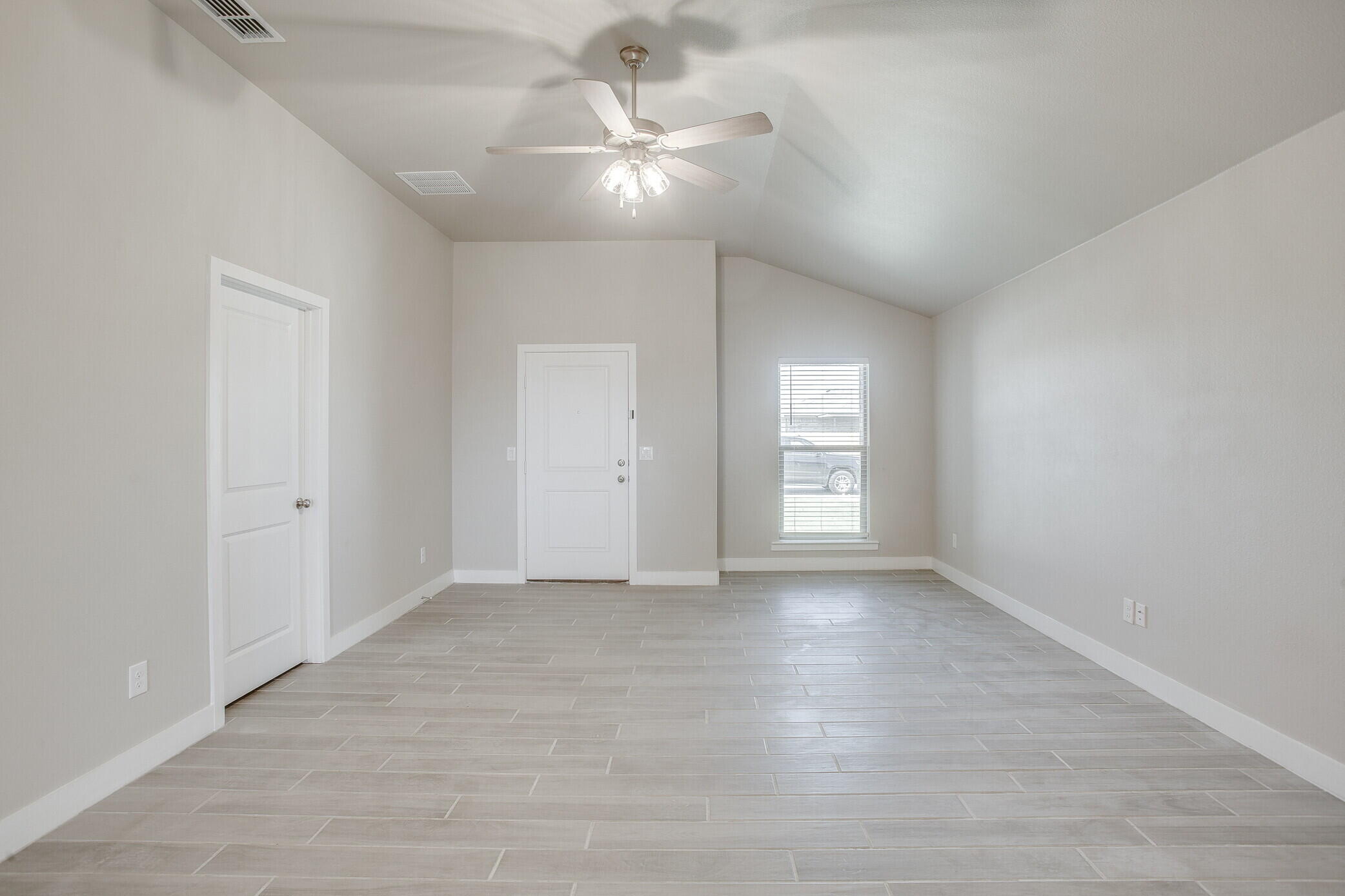 1905 140th Street Lubbock, TX 79423 - Photo 3 of 19 an empty room with fan and windows